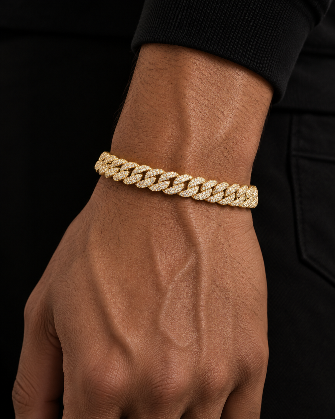 Gold-tone iced out Miami Cuban link bracelet worn on a wrist, micro-pave links